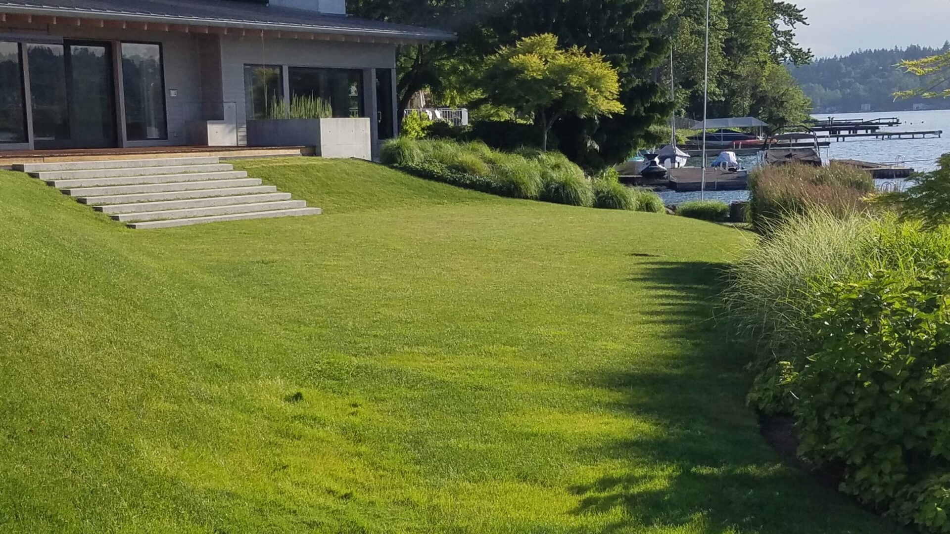 A house with a lawn that is green and has trees.